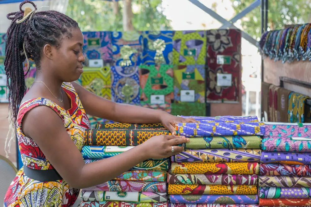 Fabric trader arranging cloth