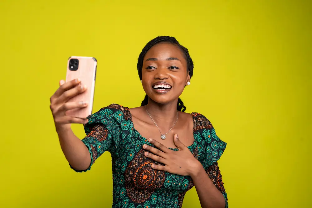 Woman laughing while taking a selfie